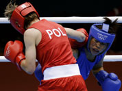 Poland`s Karolina Michalczuk, left, and fights India`s Chungneijang Mery Kom Hmangte, fight during the women`s flyweight boxing competition at the 2012 Summer Olympics.