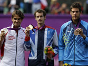From left, silver medalist Switzerland`s Roger Federer, gold medalist Andy Murray of Great Britain, and bronze medalist Juan Martin del Potro of Argentina stand during the medal ceremony of the men`s singles event at the All England Lawn Tennis Club at Wimbledon, in London.