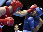 Thomas Stalker of Great Britain, left, and Manoj Kumar of India, fight during the men`s light welterweight boxing competition at the 2012 Summer Olympics