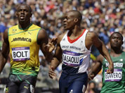 Jamaica`s Usain Bolt, left, reacts after winning ahead of Nigeria`s Ogho-Oghene Egwero, right, and Britain`s James Dasaolu in a men`s 100-meter heat during the athletics in the Olympic Stadium at the 2012 Summer Olympics.