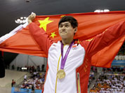 China`s Sun Yang holds his national flag as he celebrates his gold medal win in the men`s 1500-meter freestyle swimming final at the Aquatics Centre in the Olympic Park during the 2012 Summer Olympics.