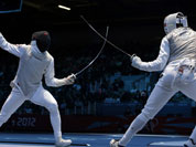 Alaaeldin Abouelkassemn of Egypt competes against James-Andrew Davis of Great Britain, right, during the men`s foil team fencing competition at the 2012 Summer Olympics.