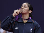 India`s Saina Nehwal kisses his bronze medal of the badminton women`s singles at the 2012 Summer Olympics, Saturday, Aug. 4, 2012, in London.