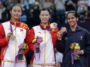 Gold medalist Li Xuerui, center, silver medalist Wang Yihan, left, both from China, and bronze medalist Saina Nehwal of India, pose at the podium of the badminton women`s singles at the 2012 Summer Olympics.