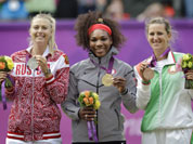 From left, silver medalist Maria Sharapova of Russia, gold medalist Serena Williams of the United States and bronze medalist Victoria Azarenka of Belarus stand on the podium during the medal ceremony of the women`s singles final match at the All England Lawn Tennis Club at Wimbledon