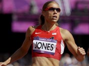 United States` Lolo Jones, left, and Canada`s Phylicia George compete in a women`s 100-meter hurdles heat during the athletics in the Olympic Stadium at the 2012 Summer Olympics.