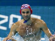Andro Buslje, center right, of Croatia puts his hand on Ravil Manafov, left, of Kazakhstan as Croatia`s Josip Pavic, back, Ivan Buljubasic defend during a preliminary men`s water polo match at the 2012 Summer Olympics.