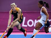 South Africa`s Bernadette Coston , left, and Kayla Bashore Smedley vie for the ball in the preliminary round women`s hockey match at the 2012 Summer Olympics.