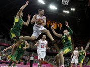 Tunisia`s Mourad El Mabrouk, center, looks to pass as he leaps between Lithuania defenders Mantas Kalnietis, left, and Paulius Jankunas (15) during a preliminary men`s basketball game at the 2012 Summer Olympics.