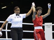 China`s Ren Cancan, right, celebrates after defeating Russia`s Elena Savelyeva, left, in a women`s flyweight 51-kg quarterfinal boxing match at the 2012 Summer Olympics.