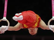 Chinese gymnast Chen Yibing performs on the rings during the artistic gymnastics men`s apparatus finals at the 2012 Summer Olympics.