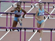 Belgium`s Eline Berings, left, Bahamas` Ivanique Kremp, center, and Kazakhstan`s Anastassiya Pilipenko, right, compete in a women`s 100-meter hurdles heat during the athletics in the Olympic Stadium at the 2012 Summer Olympics.