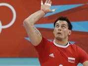 Poland`s Zbigniew Bartman (9) serves the ball to Australia during a men`s volleyball preliminary match at the 2012 Summer Olympics.