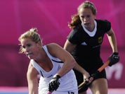 New Zealand`s Ella Gunson, front, plays a shot as Germany`s Celine Wild watches in their preliminary round women`s hockey match at the 2012 Summer Olympics.