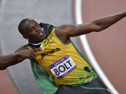 Jamaica`s Usain Bolt wears his national flag following his win in the men`s 100-meter final during the athletics in the Olympic Stadium at the 2012 Summer Olympics, London.
