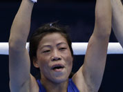 India`s Chungneijang Mery Kom Hmangte celebrates after defeating Tunisia`s Maroua Rahali in a women`s flyweight 51-kg quarterfinal boxing match at the 2012 Summer Olympics.