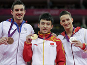 Chinese gold medallist gymnast Feng Zhe, center, Germany`s silver medallist Marcel Nguyen, right, and bronze medallist Hamilton Sabot from France display their medals for the parallel bars during the artistic gymnastics men`s apparatus finals at the 2012 Summer Olympics.