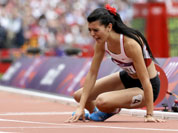 Turkey`s Merve Aydin sits down after the finish line in a women`s 800-meter heat during the athletics in the Olympic Stadium at the 2012 Summer Olympics in London