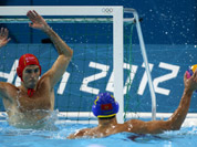 Goalkeeper Inaki Aguilar Vicente, of Spain defends against Drasko Brguljan of Montenegro during a men`s quarterfinal water polo match at the 2012 Summer Olympics, in London.