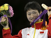 Gold medalist China`s Wu Jingyu celebrates on the podium during the medal ceremony for the women`s 49-kg taekwondo competition at the 2012 Summer Olympics.