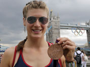United States` rower Kara Kohler holds her bronze medal in front of the tower bridge, at the 2012 Summer Olympics.