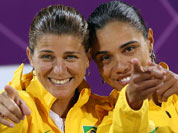 Brazil`s Larissa Franca and Juliana Silva, right, react to the fans during the women`s medal ceremonies at the 2012 Summer Olympics.