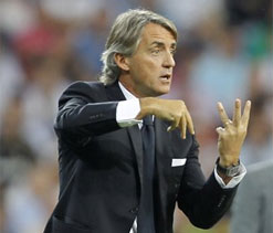 Arsenal are title contenders despite loss of Robin van Persie, insists Mancini