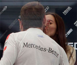 Jenson Button puckers up with girlfriend after Belgian Grand Prix win