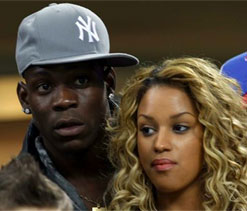 Mario Balotelli and girlfriend spotted `kissing and canoodling` during AC Milan game
