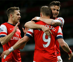 Podolski brace keeps Arsenal hopes alive for top four finish
